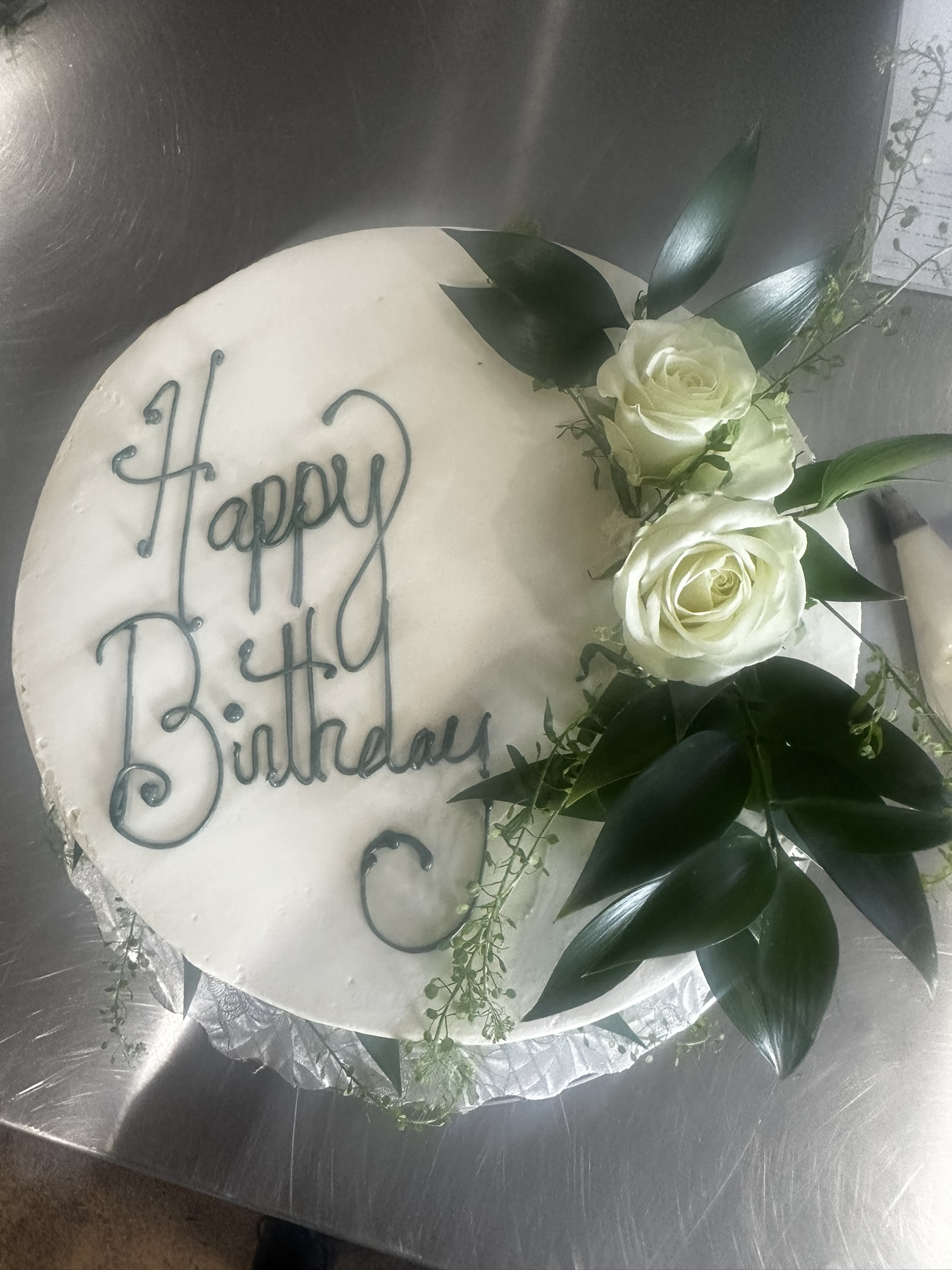 Buttercream birthday cake with purple floral accents